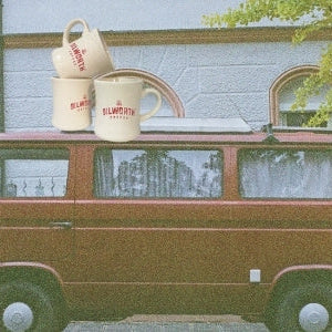 man driving shipment to coffee shop on vintage bike