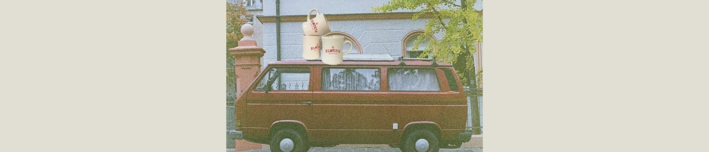 man driving shipment to coffee shop on vintage bike