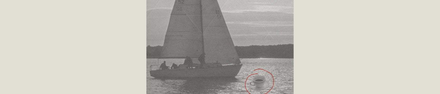 men on boat at sunset looking at a coffee floating on the ocean