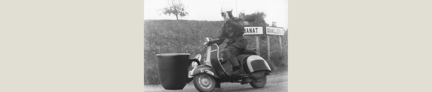 man riding motor cycle with coffee mug