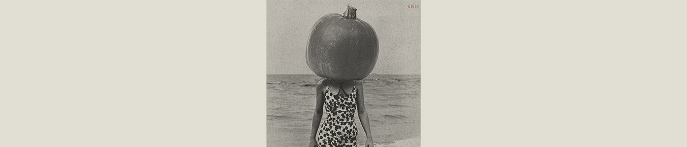 pumpkin on girl's head in the ocean
