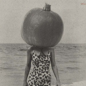 pumpkin on girl's head in the ocean