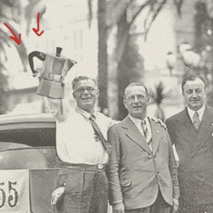 men holding brewing equipment by a vintage car
